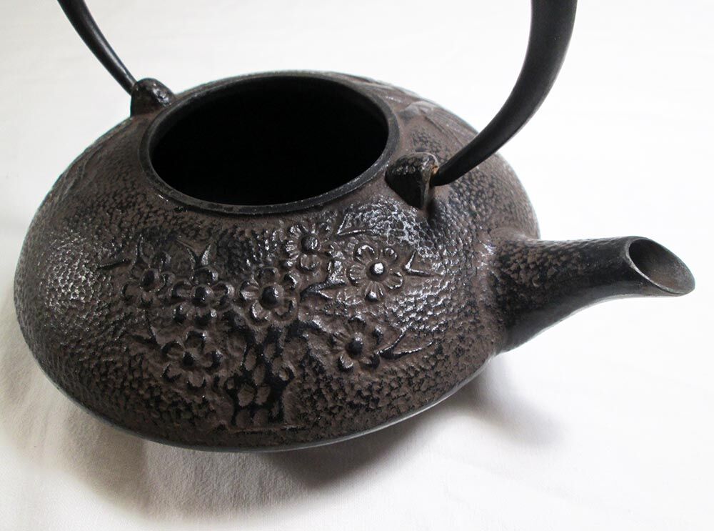 Antique cast iron teapot decorated