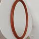 Vintage oval wooden mirror "caramel" from the 1960s.