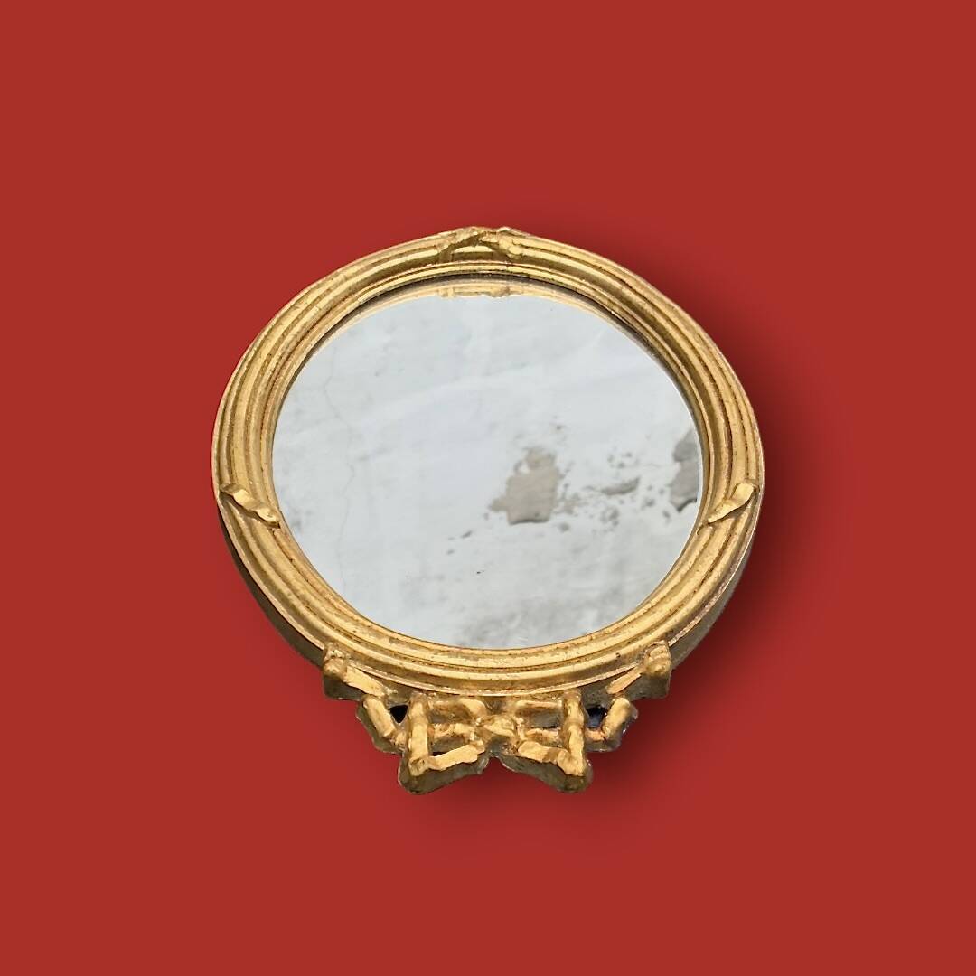 Antique oval mirror in gilded resin with Louis XVI style knot decoration