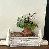 Hands tighten books in ceramics