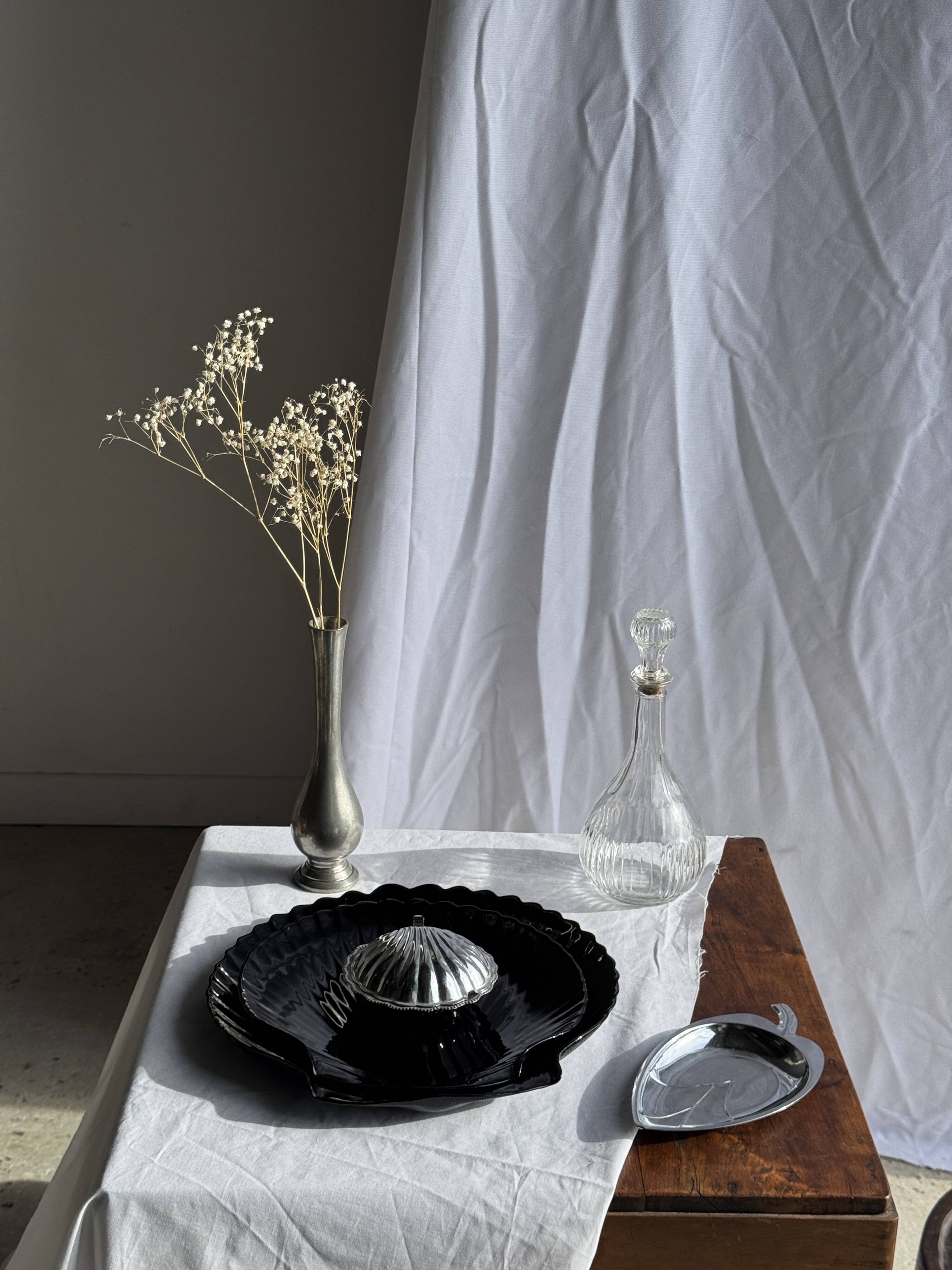 Pair of vintage black glass shell dishes D32 and D26