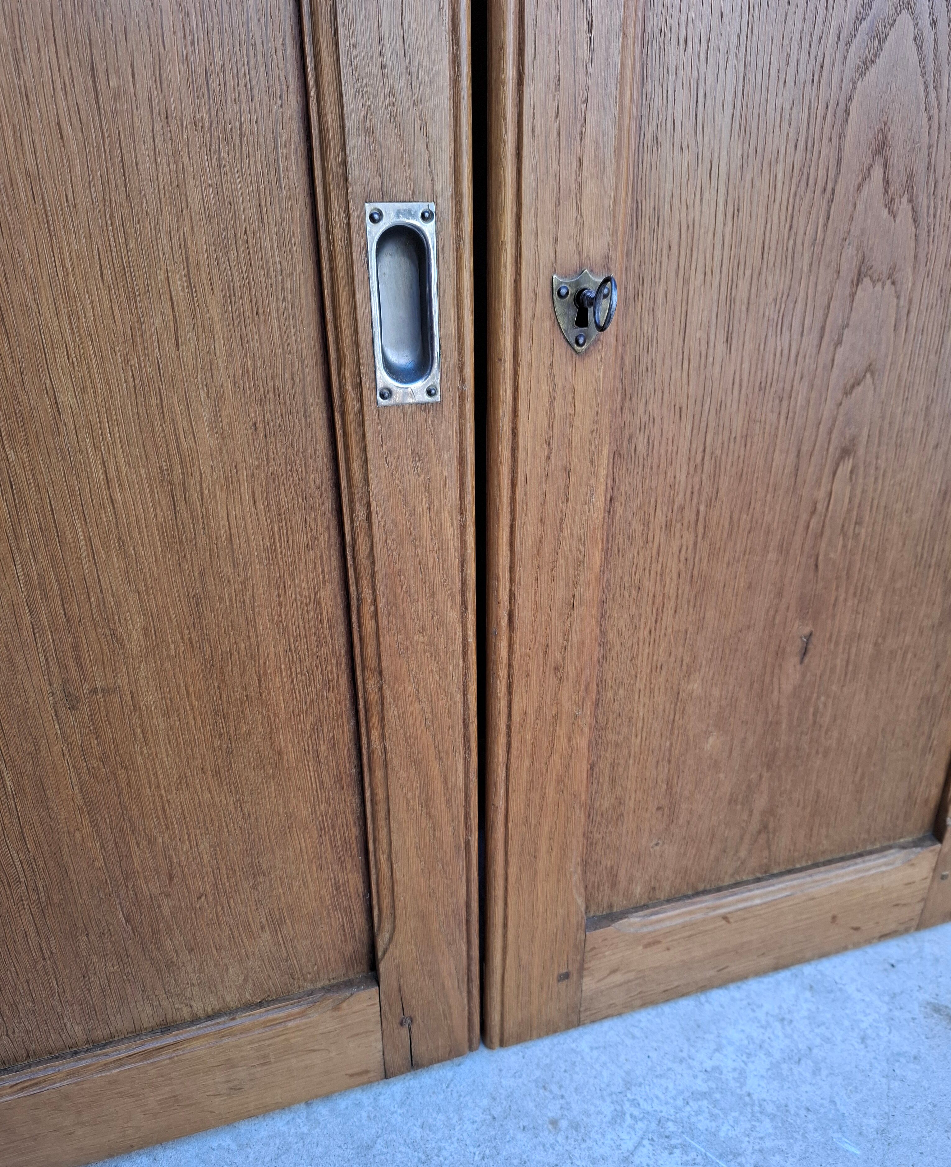 Oak workshop furniture with sliding doors.