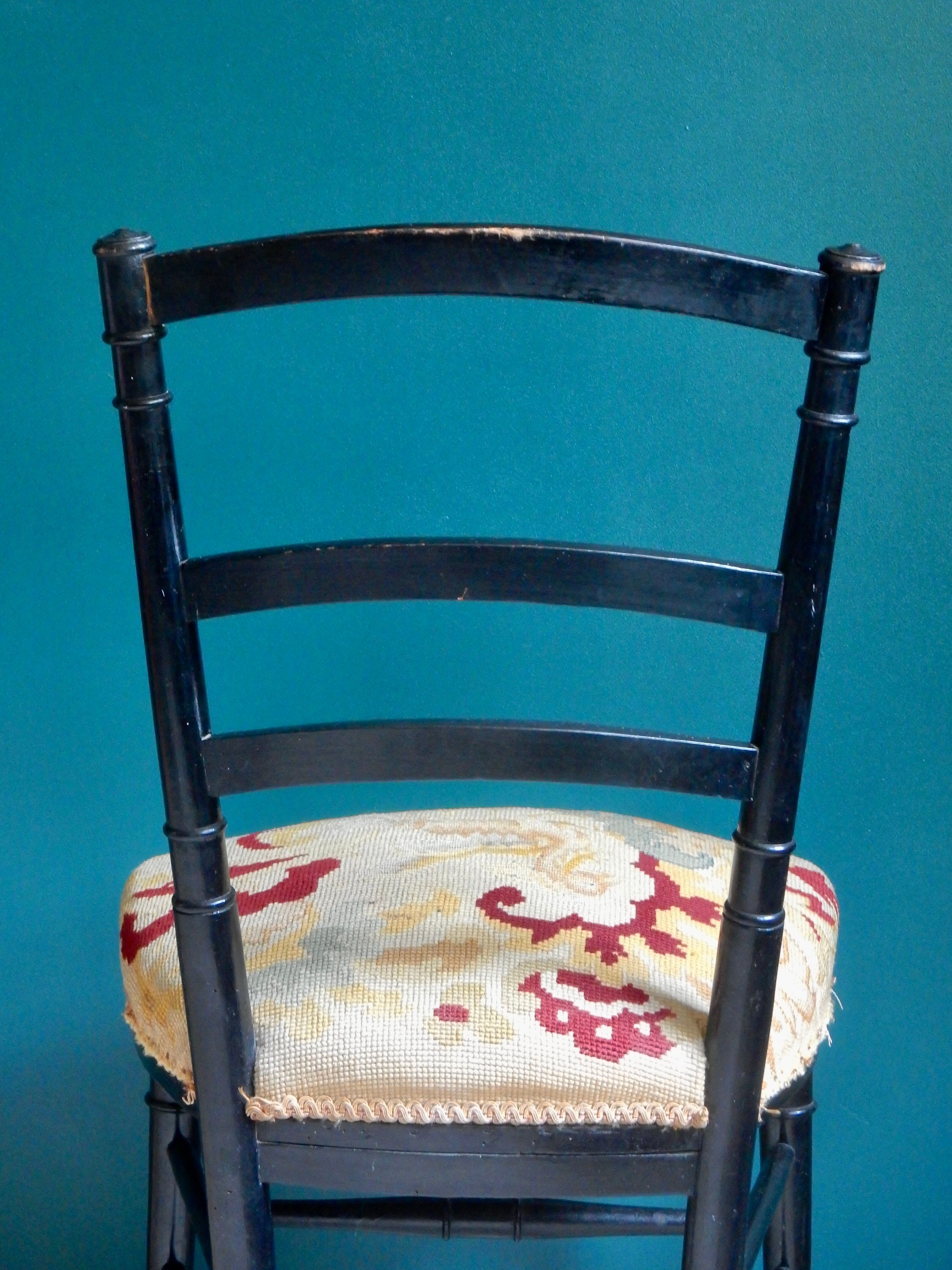 Black Napoleon III chair lined with phoenix