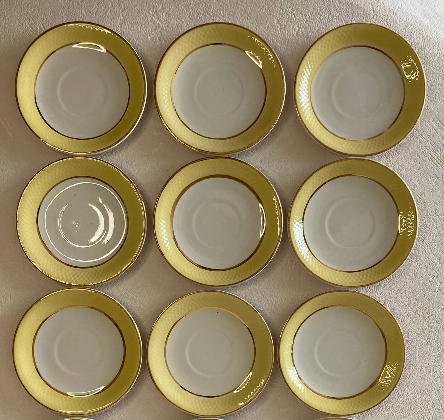 Yellow and white cups and saucers with gold trim Moulin des loups