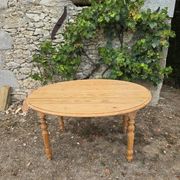Folding drop-leaf table made of raw solid wood.