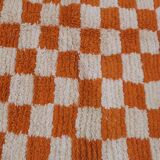 Orange checkered rug made entirely by hand