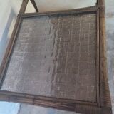 Relaxed armchair in bamboo and rattan with its small side table. Beige linen cushion.