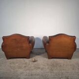 Important pair of Havana leather club armchairs, moustache models, mid-20th century.