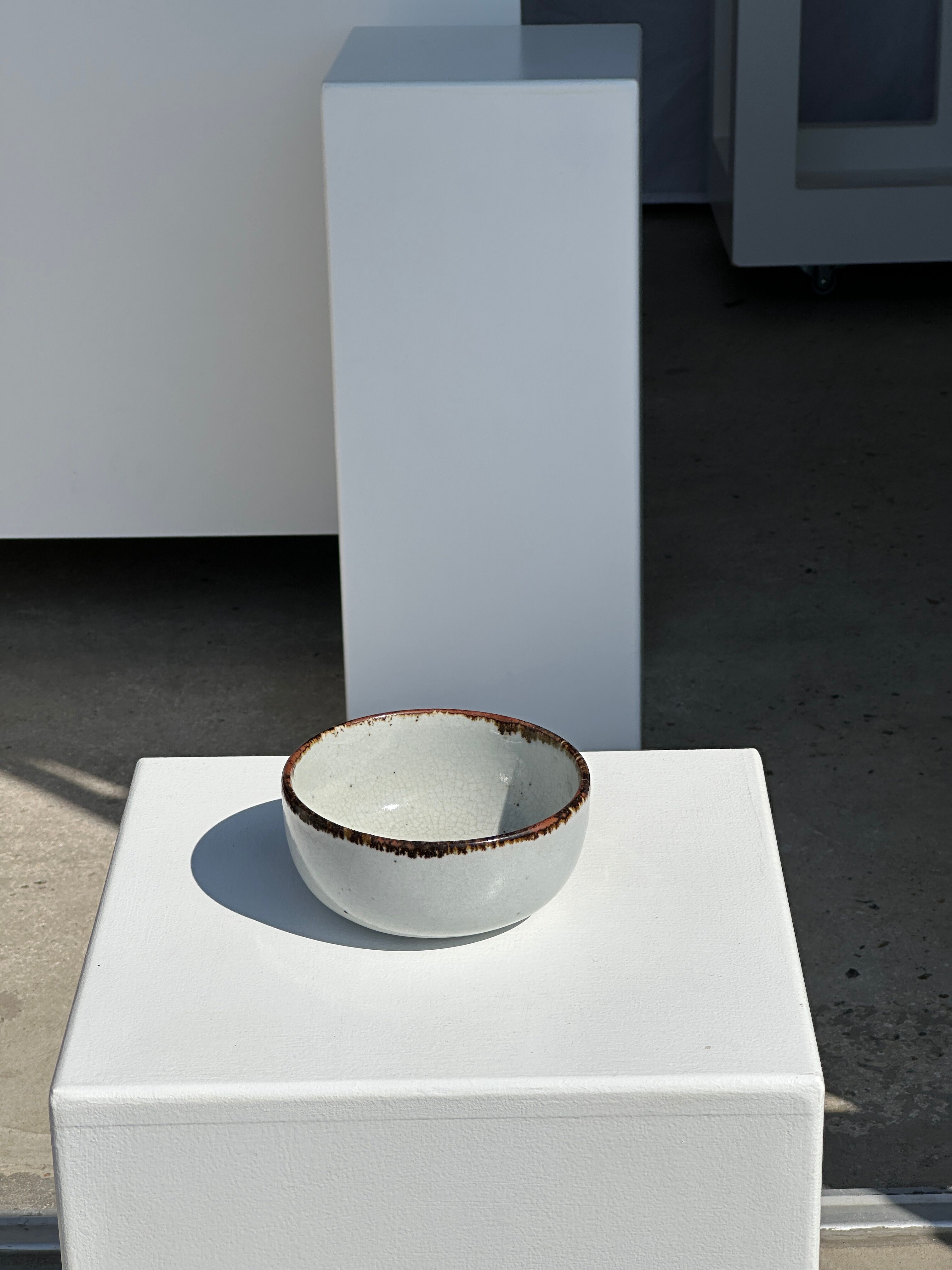Small white glazed ceramic bowl black edges