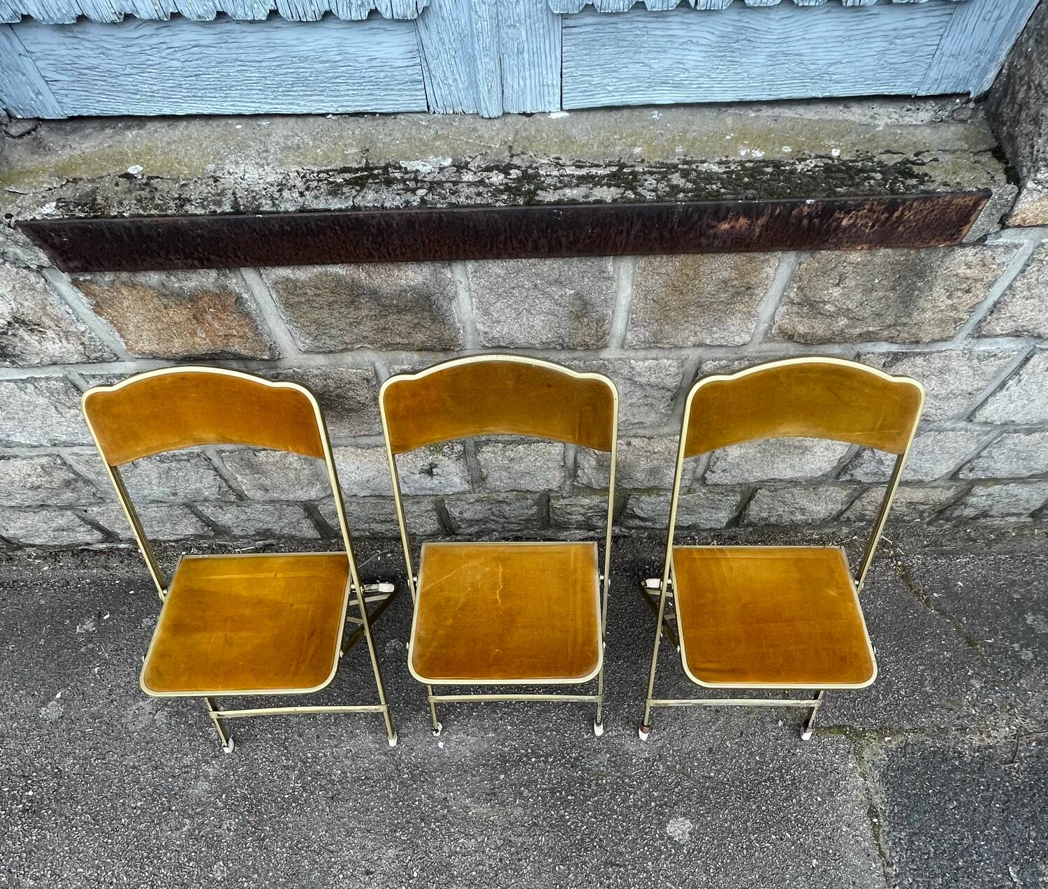 Three folding opera chairs in old gold velvet and brass structure