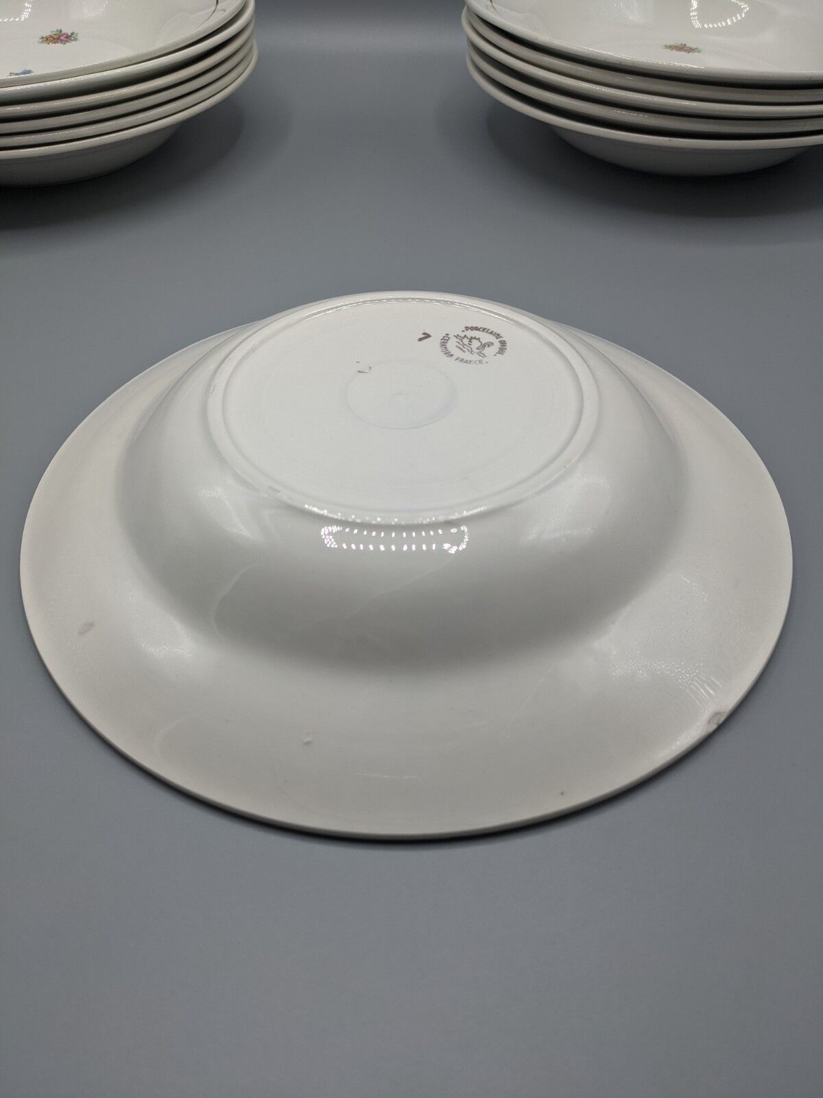 12 hollow porcelain plates, floral decoration and golden ledé - ∅: 23cm