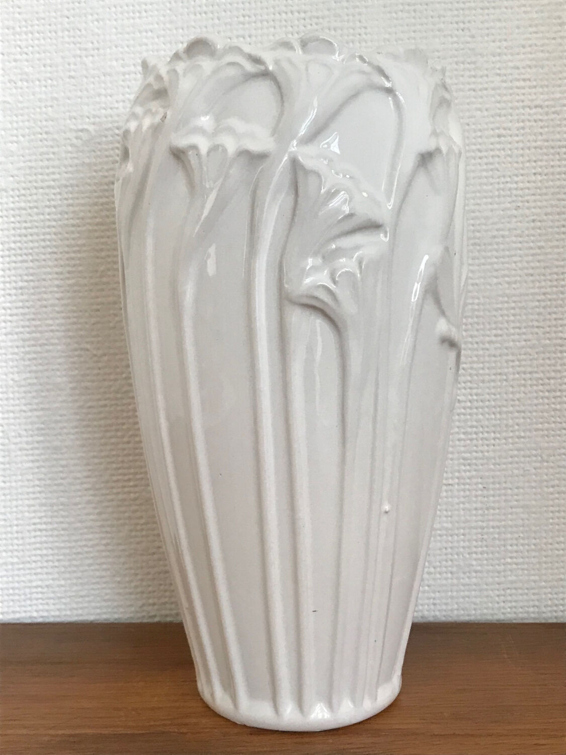 Old white art nouveau vase with flowers and dragonflies