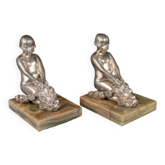 Pair of Art Deco young girls bookends in silvered bronze with onyx base