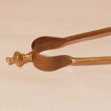 Old bronze or brass fireplace clamp
