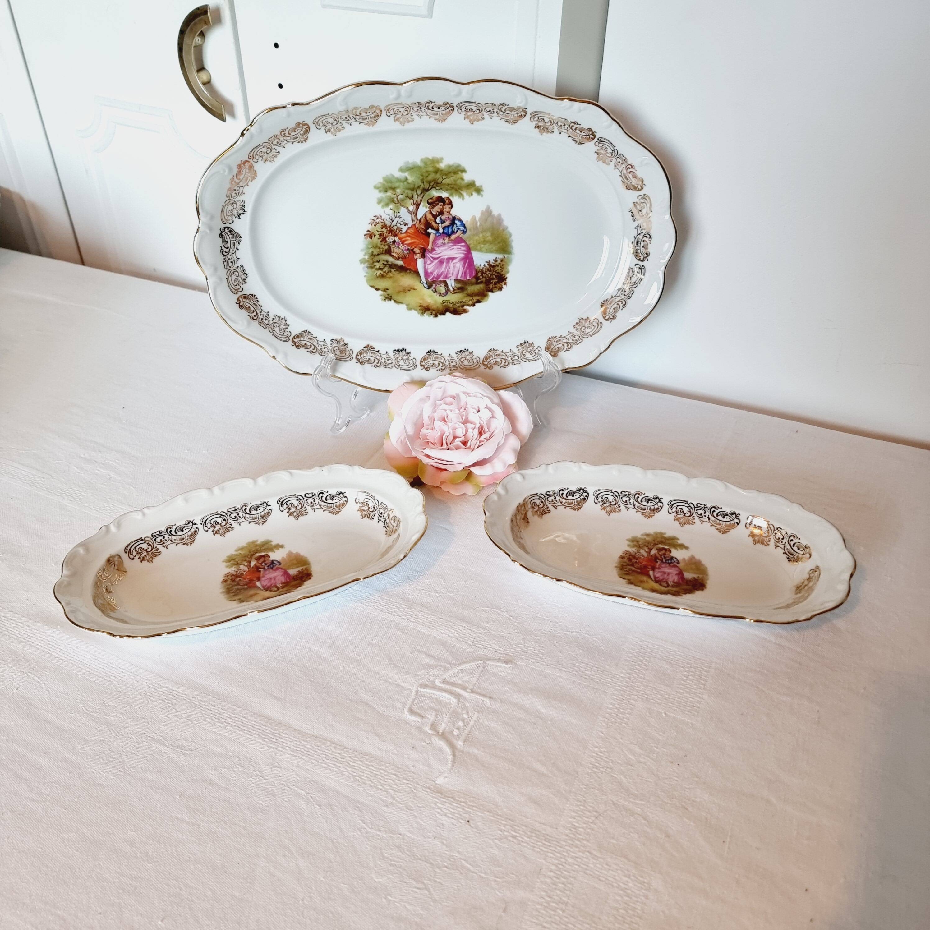 3 serving dishes with frangonard romantic scene with designs and borders in 24 carat gold.