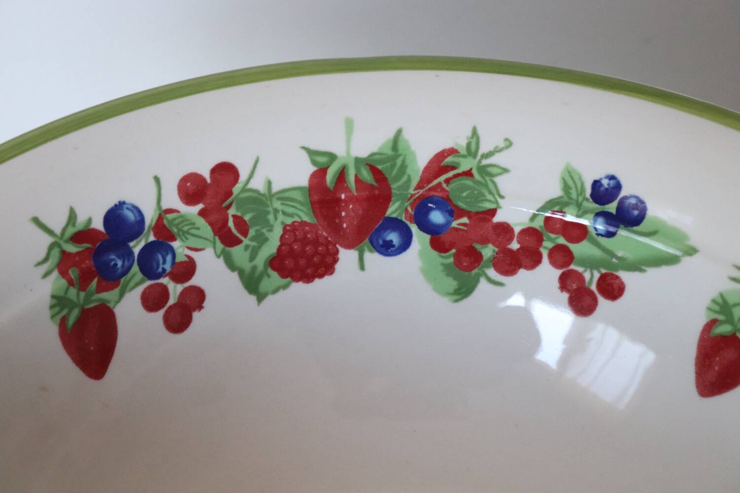 Large ceramic fruit bowl with red fruits