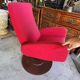 Old cinema chair with a red reclining seat.