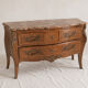 Curved Louis XV style commode in marquetry, veined marble and ornamentation.