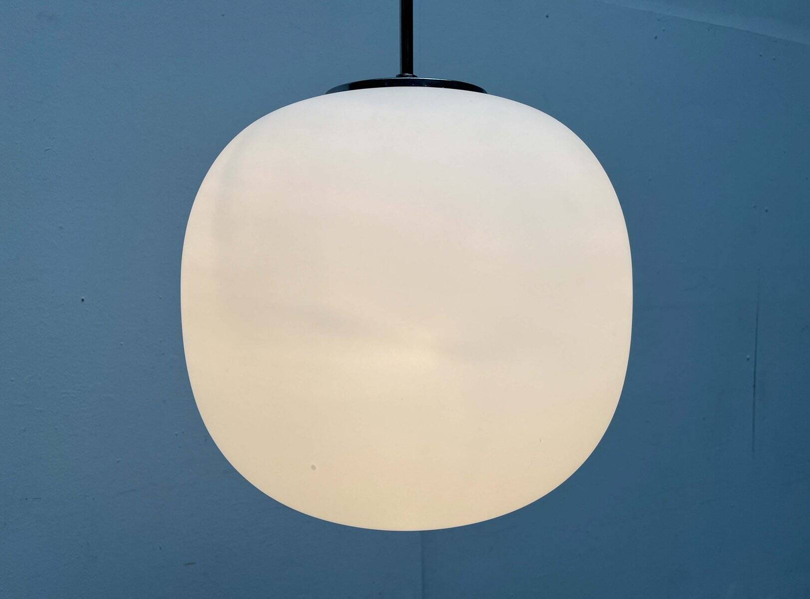 Minimalist suspended glass ball lamp from the vintage German space age by Glashütte Limburg, 1970s.