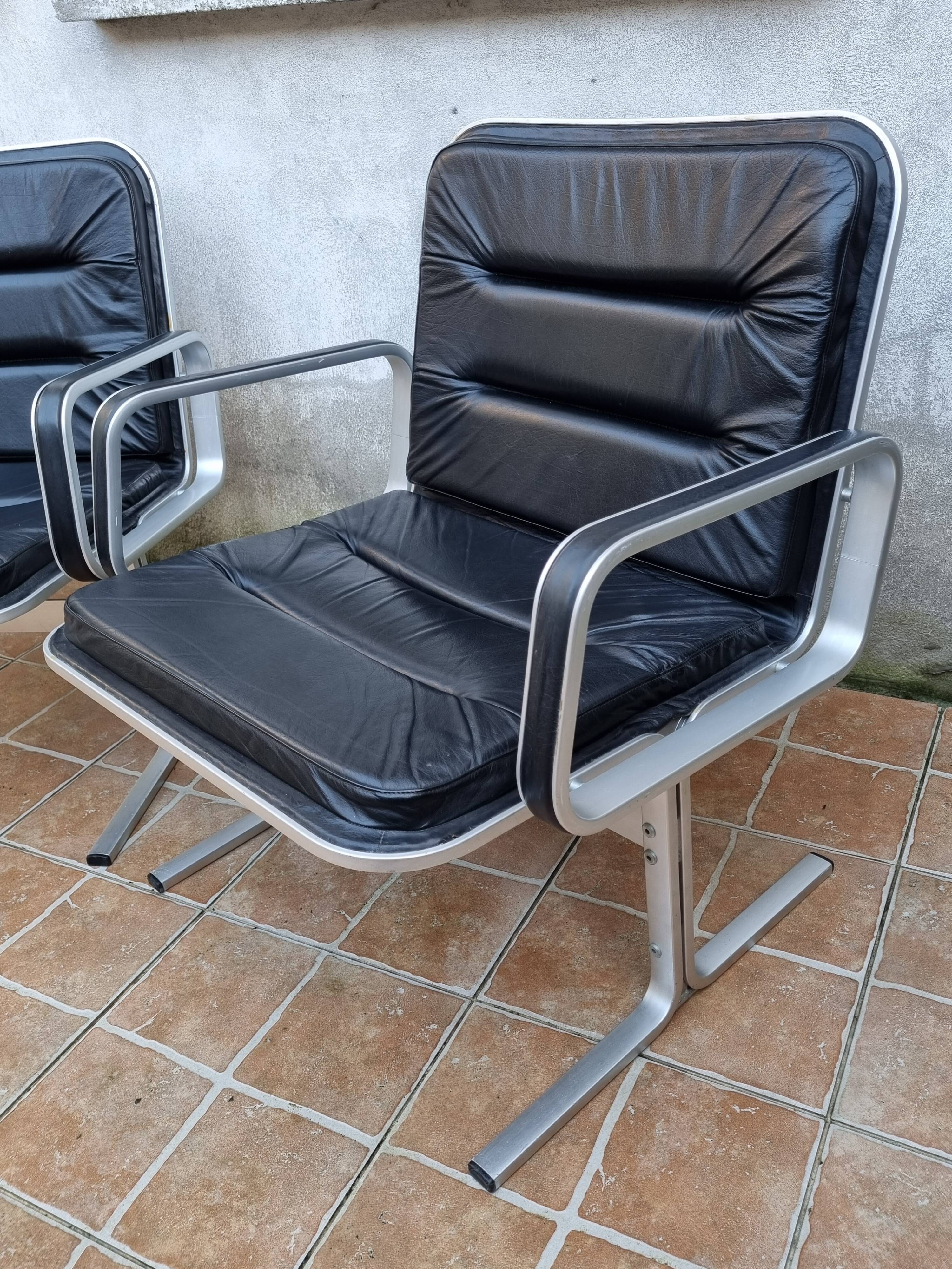 Pair of vintage leather and aluminum armchairs, restored