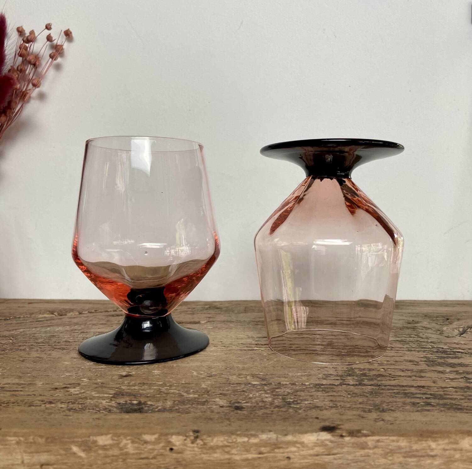 4 pink glasses with black stems