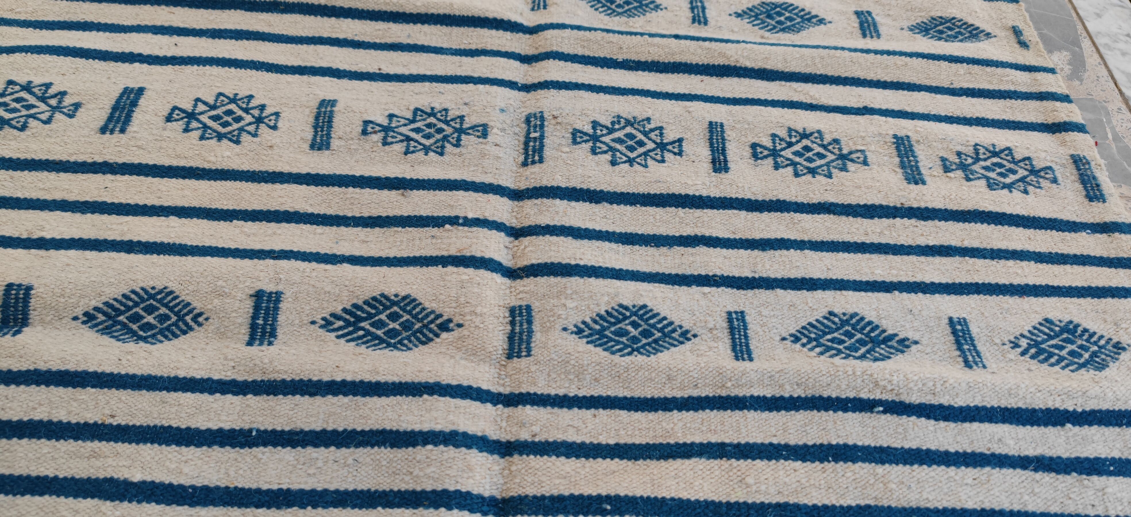 Traditional handmade white and blue kilim rug in natural wool