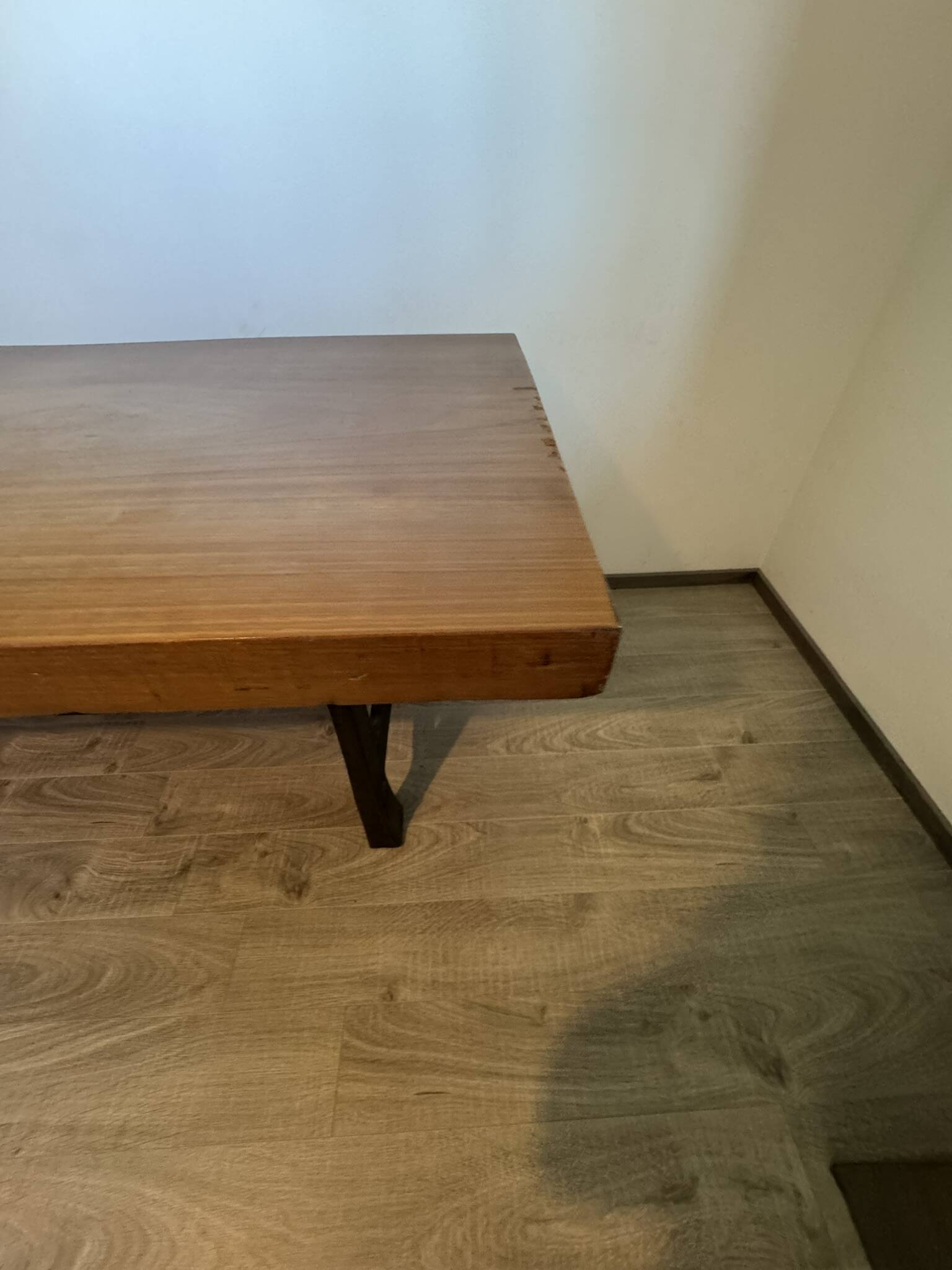 Industrial style table with a mahogany top.