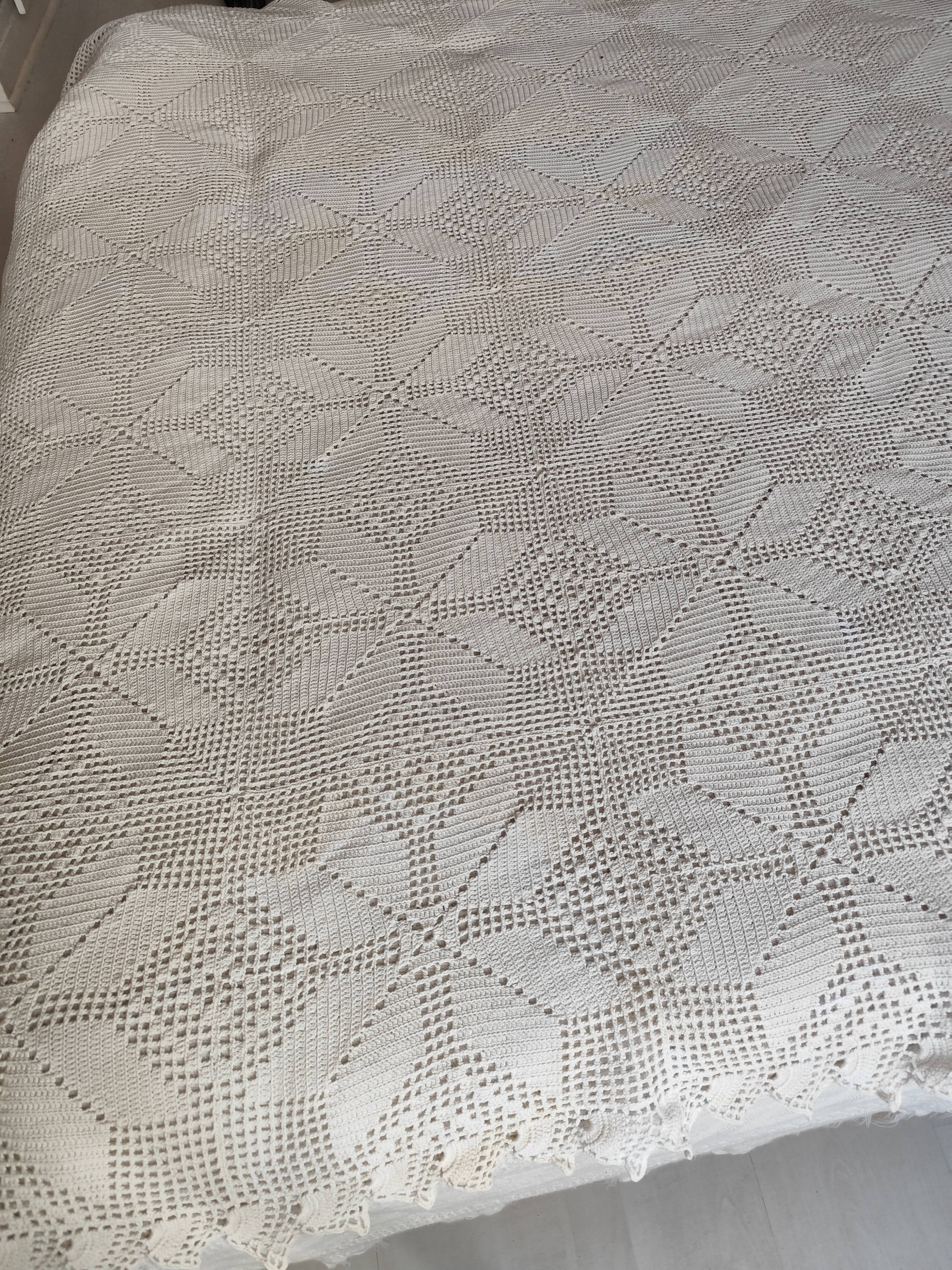 White cotton bedspread, crocheted sofa throw with star patterns