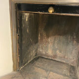 Marble fireplace surround with closed hearth frame.