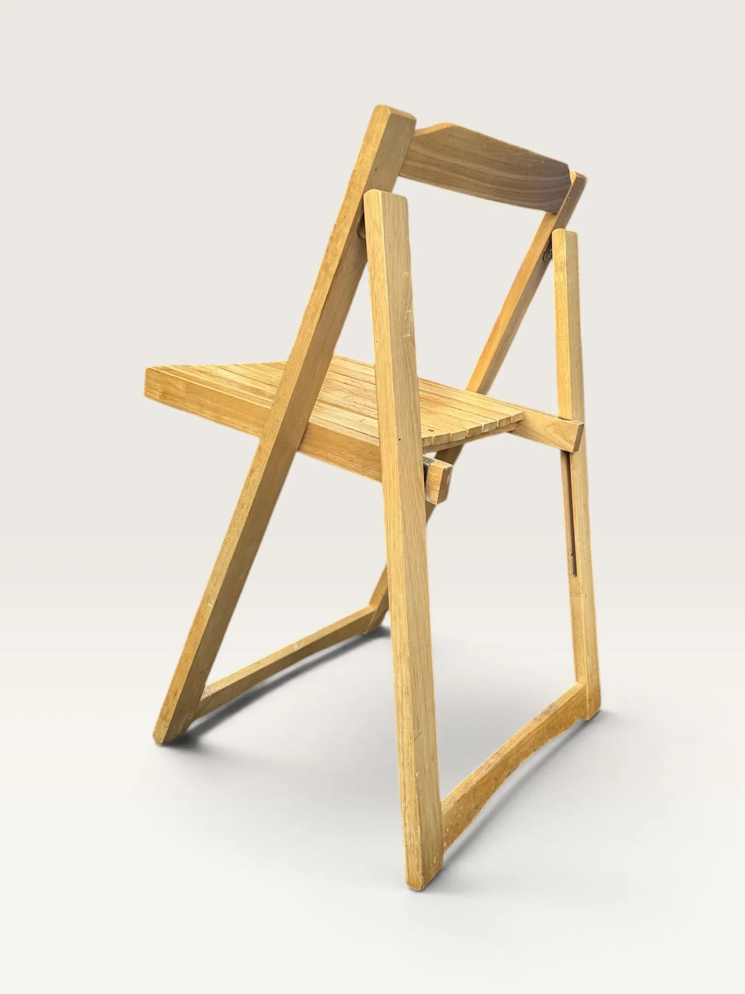 Blonde wooden folding chair in the style of Aldo Jacober.