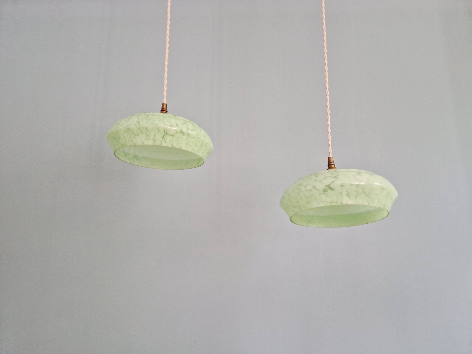 Pair of Art Deco light fixtures in light green speckled glass, 1930s.