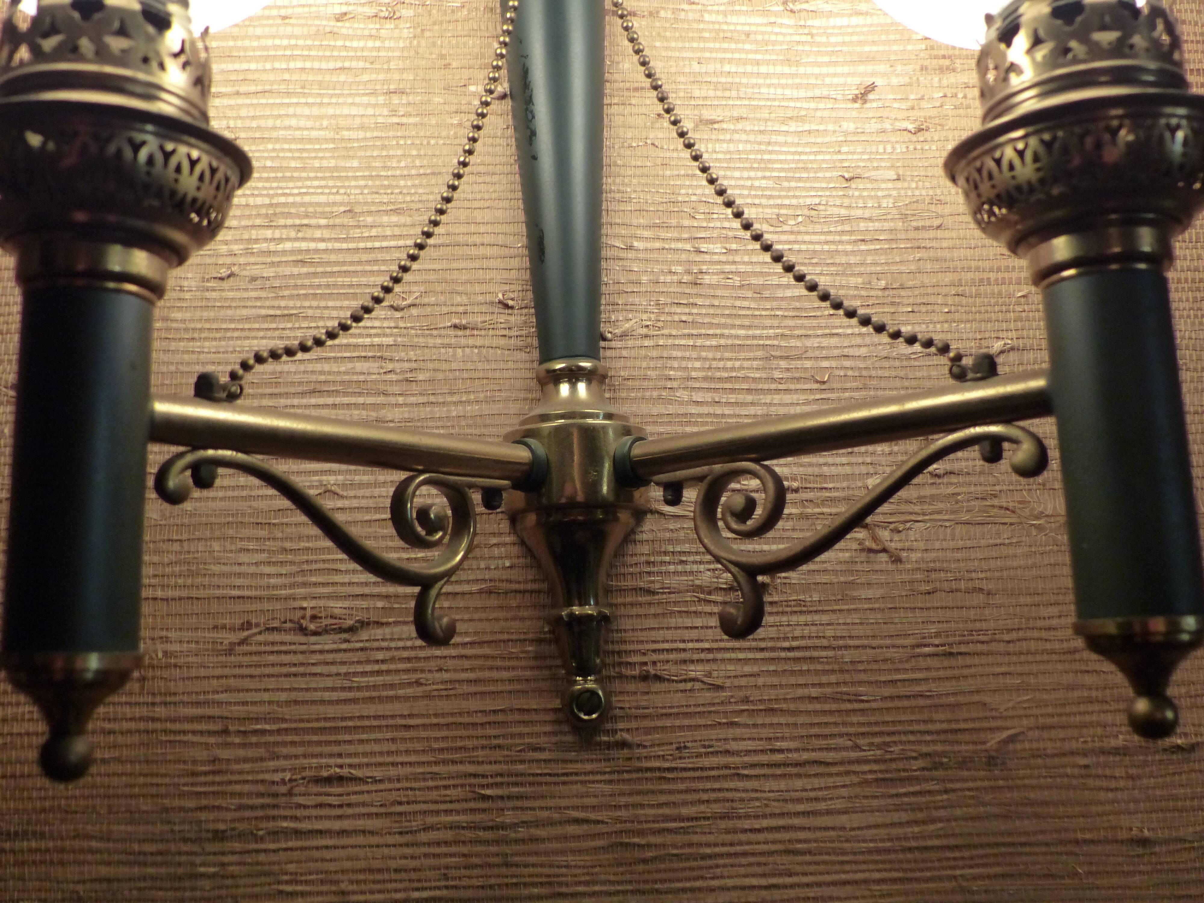 Brass wall sconce and frosted globe