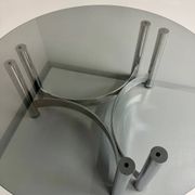 Round coffee table in smoked glass and chrome steel, 1970s design.