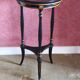 Tripod stool in blackened wood with painted floral decoration.