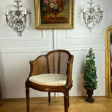 Old armchair with double cannage in walnut carved style Louis XVI of the nineteenth century