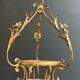 Important golden iron lantern with foliage decorations from the Baguès house.