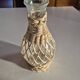vintage glass vase surrounded by woven rattan