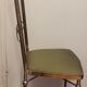 Chaise design en métal doré