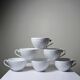 Set of 6 Bernardaud Limoges Louvre model white porcelain cups.