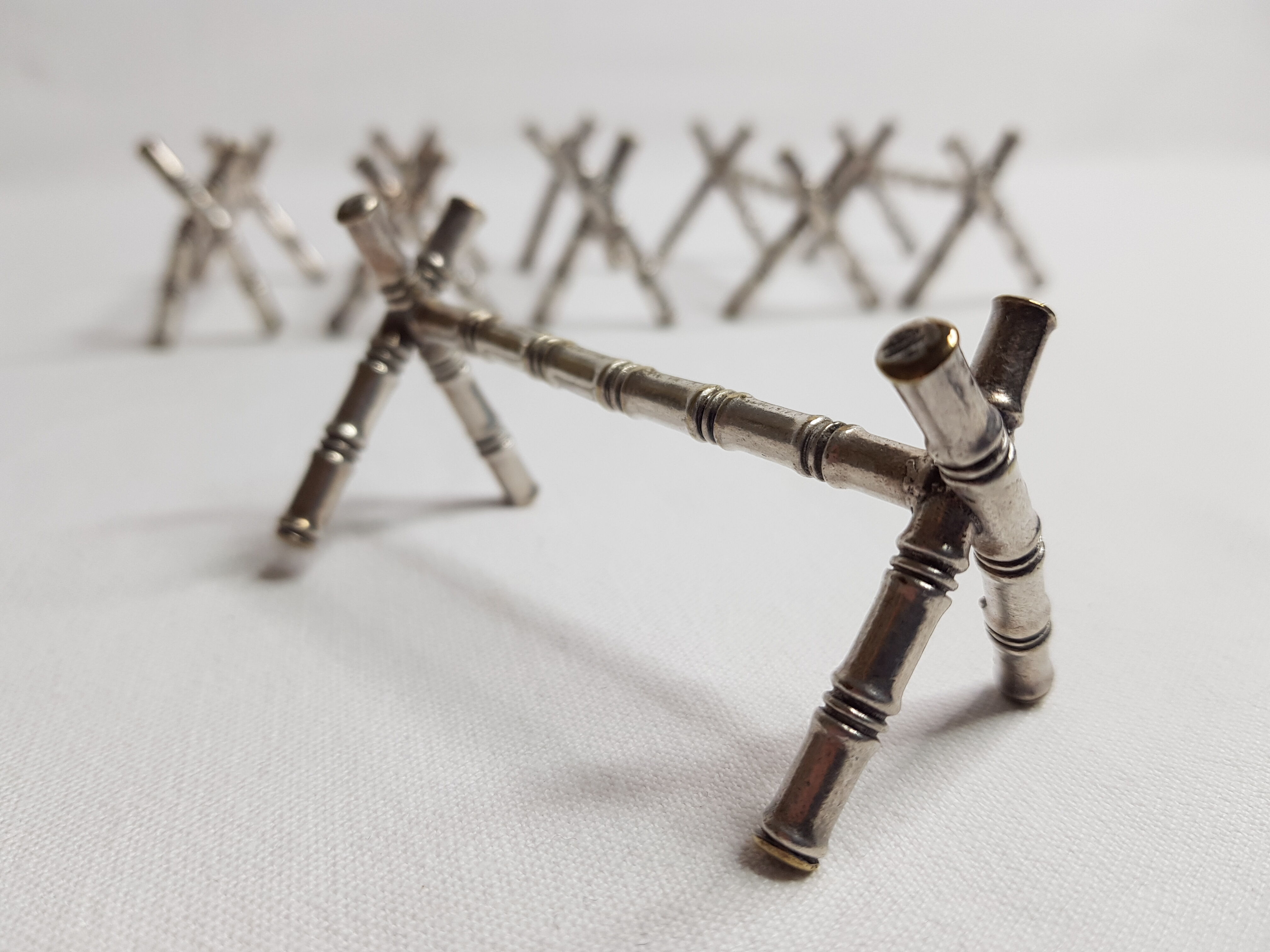 Set of six knife holders in silver metal in imitation of bamboo