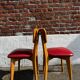 Set of 4 vintage bistro chairs in wood and red faux leather, with splayed legs.