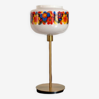 Table lamp with a vintage “flower power” glass globe and a gold base