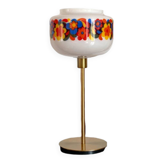 Table lamp with a vintage “flower power” glass globe and a gold base