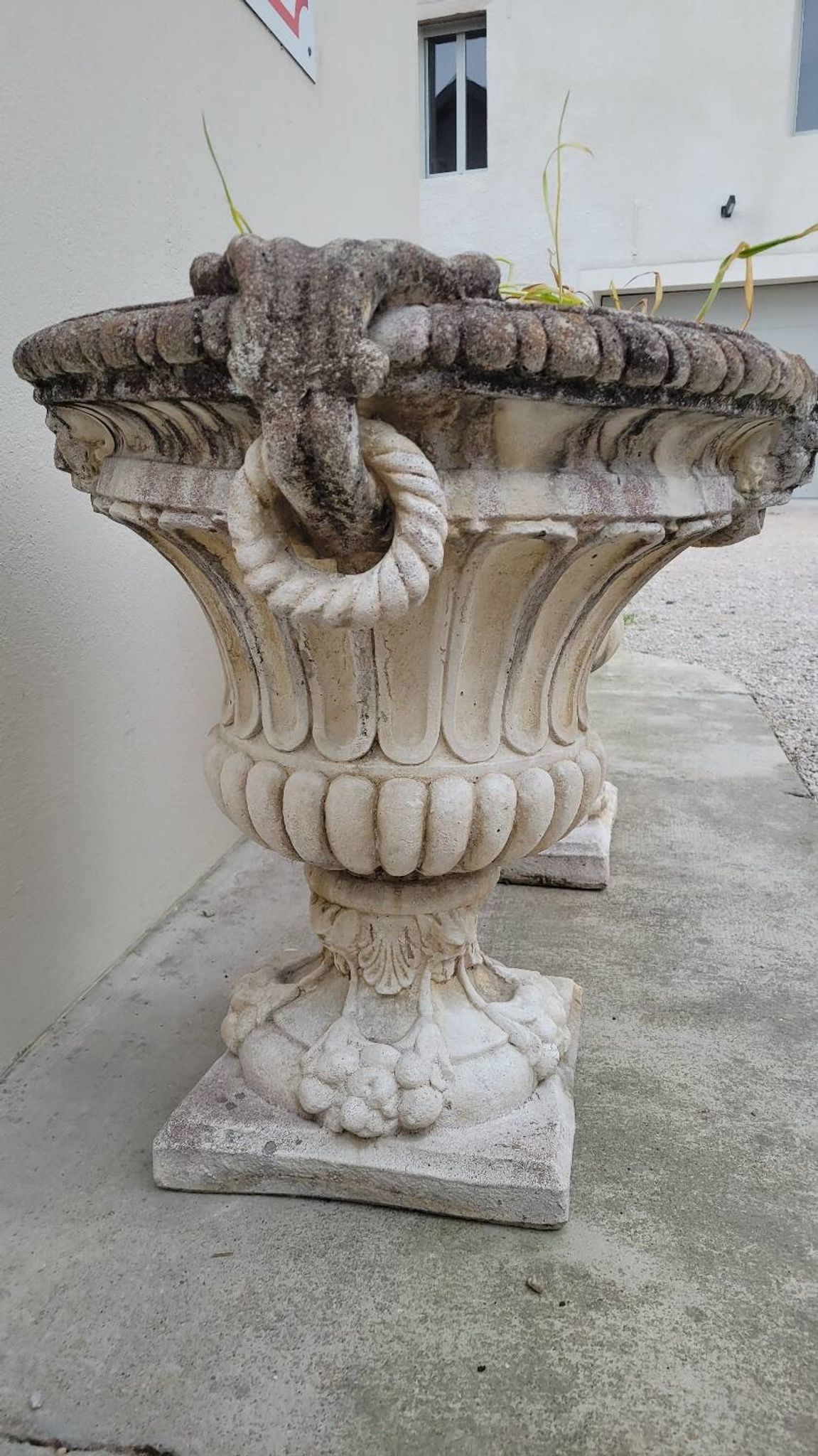 Pair of planter vases decorated with faces in reconstituted stone 1950s