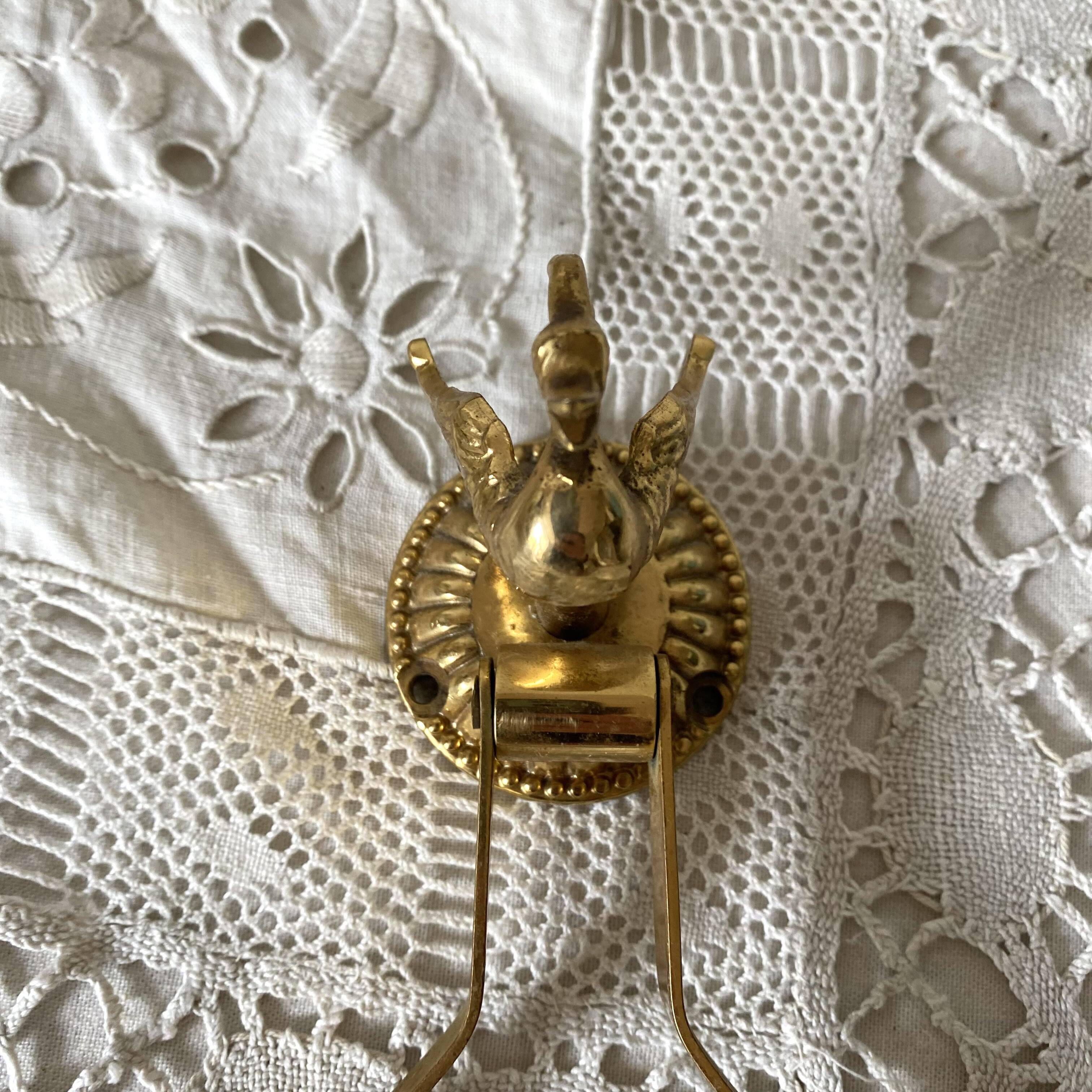 Swan toilet paper dispenser in brass