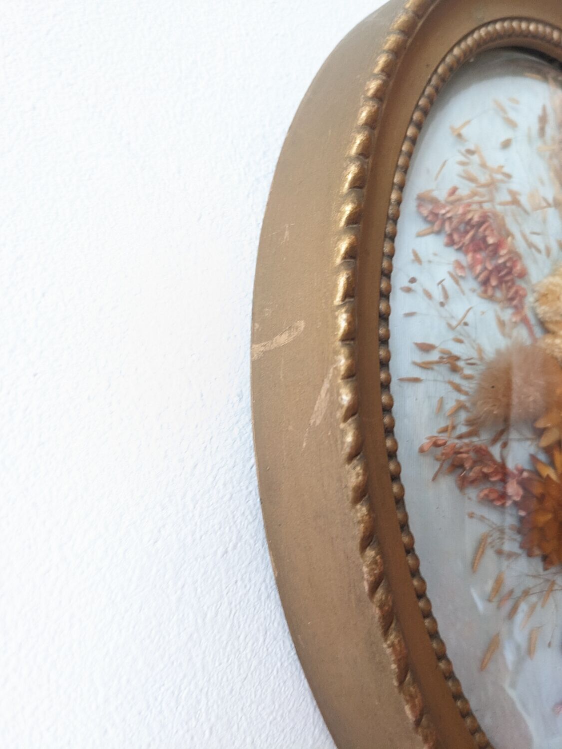 Golden vintage frame with bouquet of dried flowers under globe, wedding bouquet, antique bouquet