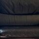 Black leather two-seater sofa
