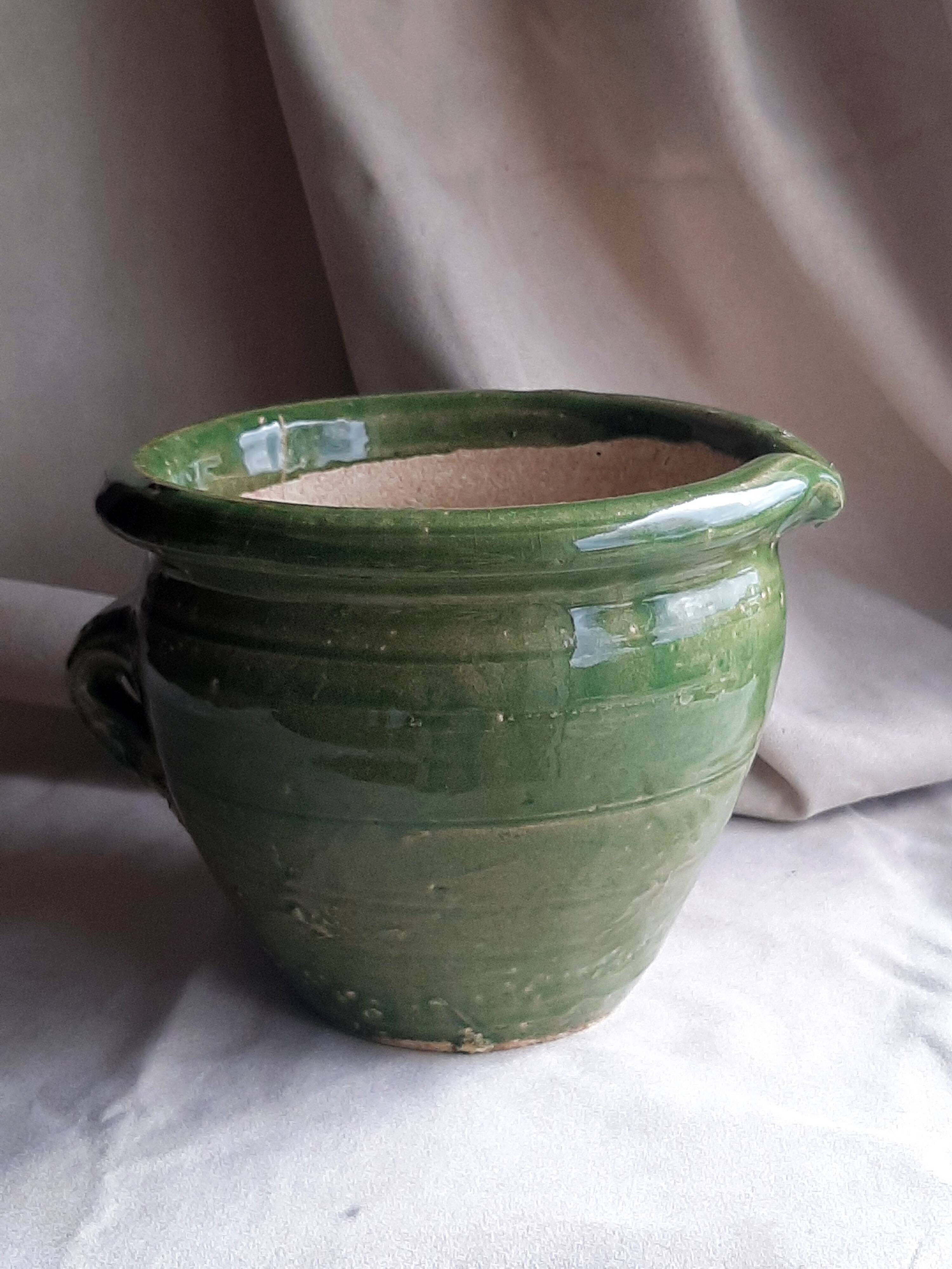 Glazed green terracotta pot.
