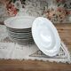 12 deep plates in porcelain with double gold trim.