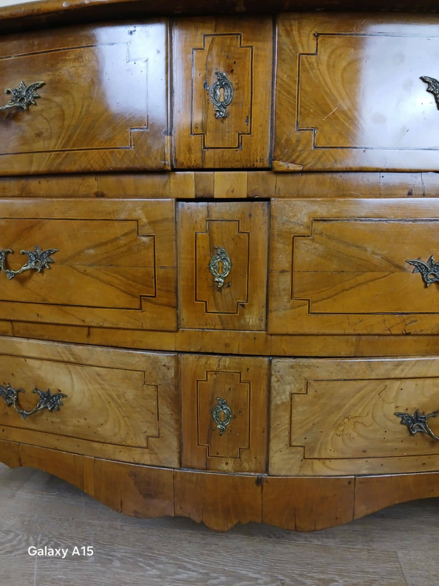 Louis XV period curved chest of drawers in elm and marquetry fillets circa 1750
